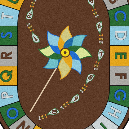 Kid Essentials Alphabet Pinwheel 7'8" x 10'9" Oval Area Rug in Color Earthtone