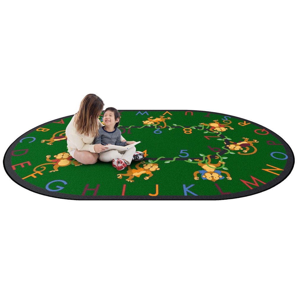 Kid Essentials Monkey Business 5'4" x 7'8" Oval Area Rug in Color Green