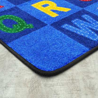 Kid Essentials Patchwork Letters 5'4" x 7'8" Area Rug in Color Multi